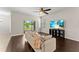 Living room featuring wood floors, a ceiling fan, and backyard access at 3426 Schoolhouse Rd, Harmony, FL 34773