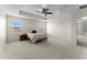 Main bedroom features carpeted floor, ceiling fan, tray ceiling and windows at 3426 Schoolhouse Rd, Harmony, FL 34773