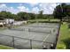 Well-maintained tennis courts with lush greenery in the background at 3426 Schoolhouse Rd, Harmony, FL 34773
