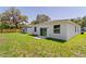 An exterior view of the backyard featuring new construction homes and a large grassy area at 3678 Rollin O Ln, Apopka, FL 32703