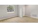 Bright room with light wood floors, white trim, a window, and a door at 3678 Rollin O Ln, Apopka, FL 32703