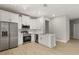 Modern kitchen with stainless steel appliances, white cabinetry, and a functional layout at 3678 Rollin O Ln, Apopka, FL 32703
