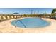 A community pool with lounge chairs and umbrellas creates a relaxing outdoor space at 471 Wayland Dr, Haines City, FL 33844