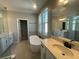 Modern bathroom with double vanities, a freestanding tub, walk-in shower, and natural light at 5324 Center Lake Ranch Blvd, St Cloud, FL 34771