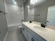 Well-lit bathroom with double vanity, tub and shower combo, and modern fixtures at 5324 Center Lake Ranch Blvd, St Cloud, FL 34771