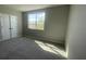 Sunlit bedroom with plush carpeting, large window, and closet with double doors at 5324 Center Lake Ranch Blvd, St Cloud, FL 34771
