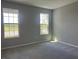 Carpeted bedroom with natural light, featuring dual windows that overlook the exterior landscape at 5324 Center Lake Ranch Blvd, St Cloud, FL 34771