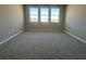Spacious bedroom with three large windows offering plenty of natural light and carpeted floors at 5324 Center Lake Ranch Blvd, St Cloud, FL 34771