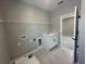 Laundry room with a utility sink, shelving, and connections, adjacent to another room at 5324 Center Lake Ranch Blvd, St Cloud, FL 34771