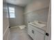 The laundry room offers a utility sink with a storage cabinet underneath and overhead wire shelving at 5324 Center Lake Ranch Blvd, St Cloud, FL 34771