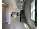 Open-concept living space featuring tile floors, modern lighting, and a staircase leading to the upper level at 5324 Center Lake Ranch Blvd, St Cloud, FL 34771