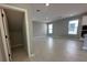 Open living room with hardwood floors leading to a kitchen with white cabinetry and modern appliances at 5324 Center Lake Ranch Blvd, St Cloud, FL 34771