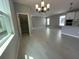 Living space with large windows, hardwood floors, and modern lighting fixtures, flowing into the kitchen at 5324 Center Lake Ranch Blvd, St Cloud, FL 34771