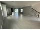 Expansive living room featuring hardwood floors, modern lighting, and a seamless flow into the kitchen at 5324 Center Lake Ranch Blvd, St Cloud, FL 34771
