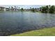 Scenic view of the community's tranquil lake, surrounded by well-maintained landscaping and multiple condo buildings at 5501 Pga Blvd # 4723, Orlando, FL 32839