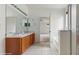 Well-lit bathroom features a double sink vanity, tile floors, and a shower-tub combo at 579 Setting Sun Dr, Winter Garden, FL 34787