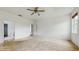 A spacious bedroom features carpet floors, ceiling fan, ensuite bath, and neutral paint at 579 Setting Sun Dr, Winter Garden, FL 34787