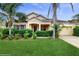 Charming single-story home with a well-manicured lawn and tropical landscaping, creating a welcoming curb appeal at 579 Setting Sun Dr, Winter Garden, FL 34787