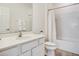 Bright bathroom features a white vanity, toilet, and shower-tub combo with white tile surround at 6112 Broad Oak Dr, Davenport, FL 33837