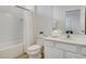 Well-lit bathroom featuring a tub with shower, modern sink, and wood-look tile flooring at 6112 Broad Oak Dr, Davenport, FL 33837