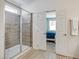 Contemporary bathroom featuring a glass-enclosed shower with gray tiling and wood-look flooring at 6112 Broad Oak Dr, Davenport, FL 33837