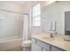 Bright bathroom features a white vanity, toilet, and shower-tub combo with bright white tile at 6112 Broad Oak Dr, Davenport, FL 33837