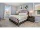 Bright bedroom with neutral color scheme, two windows and comfortable bed and side tables at 6112 Broad Oak Dr, Davenport, FL 33837
