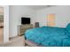 Comfortable bedroom featuring a TV, dresser and an open doorway to a hallway at 6112 Broad Oak Dr, Davenport, FL 33837
