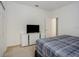 Comfortable bedroom featuring a TV atop a modern dresser and neutral carpeting at 6112 Broad Oak Dr, Davenport, FL 33837