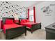 Bright bedroom featuring two beds with red bedding and fun Mickey Mouse themed wallpaper at 6112 Broad Oak Dr, Davenport, FL 33837