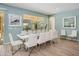 Charming dining area featuring a modern table with seating for ten and serene aqua walls at 6112 Broad Oak Dr, Davenport, FL 33837