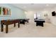 Spacious game room featuring foosball, a billiards table, and ample space for entertaining at 6112 Broad Oak Dr, Davenport, FL 33837