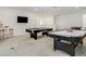 Fun game room with a pool table, air hockey, a wet bar, and lounge area at 6112 Broad Oak Dr, Davenport, FL 33837