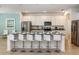 Modern kitchen featuring a large island with seating, stainless steel appliances, and sleek cabinetry at 6112 Broad Oak Dr, Davenport, FL 33837