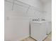 Bright laundry room features modern appliances and plenty of shelving for storage at 6112 Broad Oak Dr, Davenport, FL 33837