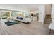 Spacious living room with tile flooring, a large sofa, and seamless transition to the kitchen and dining areas at 6112 Broad Oak Dr, Davenport, FL 33837