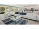 Bright living room with modern decor, a large sofa, and an open view to the kitchen and dining area at 6112 Broad Oak Dr, Davenport, FL 33837