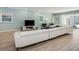 Bright living room with an extra large sofa, tile flooring, and access to the outdoor area at 6112 Broad Oak Dr, Davenport, FL 33837