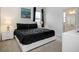 Comfortable main bedroom boasts a plush queen bed, accent lamps, and ensuite bath access at 6112 Broad Oak Dr, Davenport, FL 33837