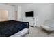 Well-lit main bedroom offers a TV, dresser, chair, and a comfortable bed at 6112 Broad Oak Dr, Davenport, FL 33837