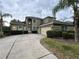 Two-story home featuring a long driveway, well-manicured landscaping, and an attached two-car garage at 6224 Zane Dr, Mount Dora, FL 32757