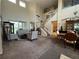 Spacious living room with high ceilings, carpeted floor, a staircase, and comfortable seating area at 6224 Zane Dr, Mount Dora, FL 32757