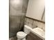 Bathroom showcasing a modern toilet, vanity, sink, and stylish tile work at 7727 Glynde Hill Dr, Orlando, FL 32835