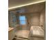 Modern bathroom featuring a luxurious soaking tub and a separate glass-enclosed shower at 7727 Glynde Hill Dr, Orlando, FL 32835