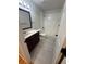 Well-lit bathroom featuring a vanity with a sink, toilet, and a shower-tub combo at 7727 Glynde Hill Dr, Orlando, FL 32835