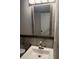 Bathroom featuring modern sink, faucet, framed mirror, and tile backsplash at 7727 Glynde Hill Dr, Orlando, FL 32835