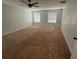 Spacious bedroom offering neutral paint, carpet, and windows to bring in lots of natural light at 7727 Glynde Hill Dr, Orlando, FL 32835