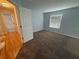 Bright bedroom with neutral walls, plush carpeting, and a large window, perfect for relaxation at 7727 Glynde Hill Dr, Orlando, FL 32835