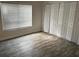 Bright bedroom features lots of natural light, spacious closet, and modern flooring at 7727 Glynde Hill Dr, Orlando, FL 32835