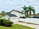 View of home with well-manicured lawn, white fence, and a two car garage, perfect for Gathering living at 7727 Glynde Hill Dr, Orlando, FL 32835